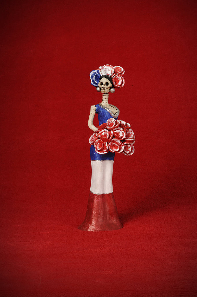 Catrina Mini Miss France is stunning like her big sister.   This beautiful mini is wearing a sleek body contouring gown that resembles France's flag. To complement her look, we gave her a beautiful red flower bouquet and a headpiece that beautifully matches her dress.  She will make a great addition to your Catrina collection!