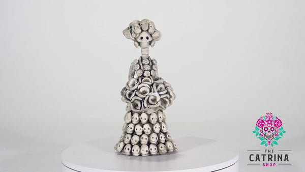 Veronica is the smallest Catrina in our Day of the Dead collection. The attention to detail and impressive workmanship are showcased with multiple skulls placed on her dress, creating an unbelievable pattern.  Veronica is a cute little thing that will add a special touch to your ofrenda!