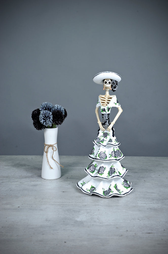 Introducing Catrina Norma from our Grand Collection.  Norma is a stunning Catrina with incredible details on her face and gown. Her gorgeous white dress has black roses that match her headpiece.   Add a classy touch of Mexican art to your home. 