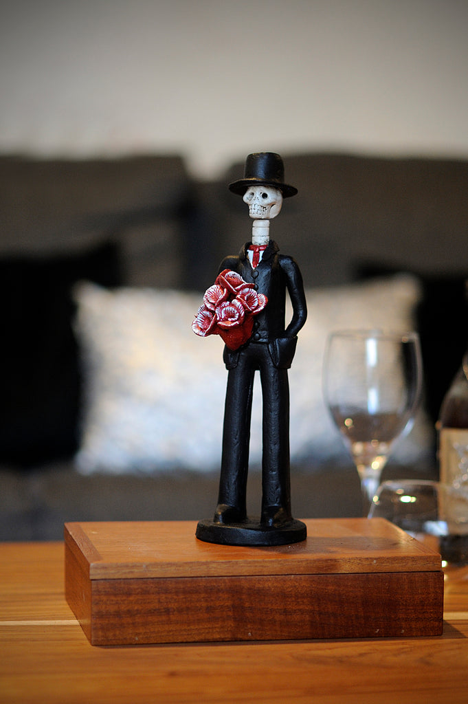 Hand-made clay figurine, Diego in Red is one of our handsome Catrines. He compliments all our Catrinas with red flower bouquets, or by himself. All our Catrines and Catrinas are made in Mexico and we ship worldwide. Add a classy touch of Mexican culture to your home.