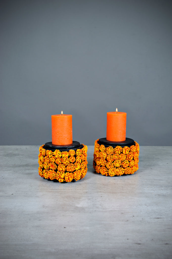 This beautiful set of candleholders is the perfect addition to your Day of the Dead altar or as decoration in your home. The cempazuchil candleholders are decorated with cempazuchil (Marigold) flowers all around. All of the flowers are individually made by hand.   This set comes with lids for both candleholders; you can place decorations on top of them or use them without the lid.