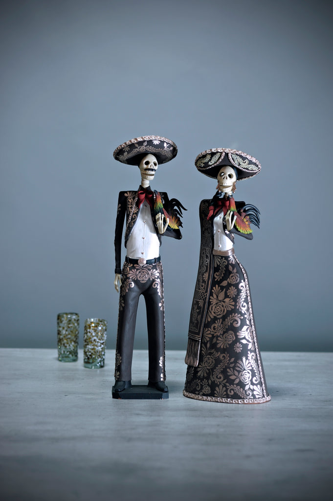 Introducing Catrines Leonor and Alejandro from our Grand Collection.  They are both wearing a stunning brown Charro suit with an intricate hand-painted design in gold, and for added decoration, they are both holding colorful roosters.  The artisan did an outstanding job creating these pieces that add a stylish touch to any home, and it accurately represents Mexico and its beauty.
