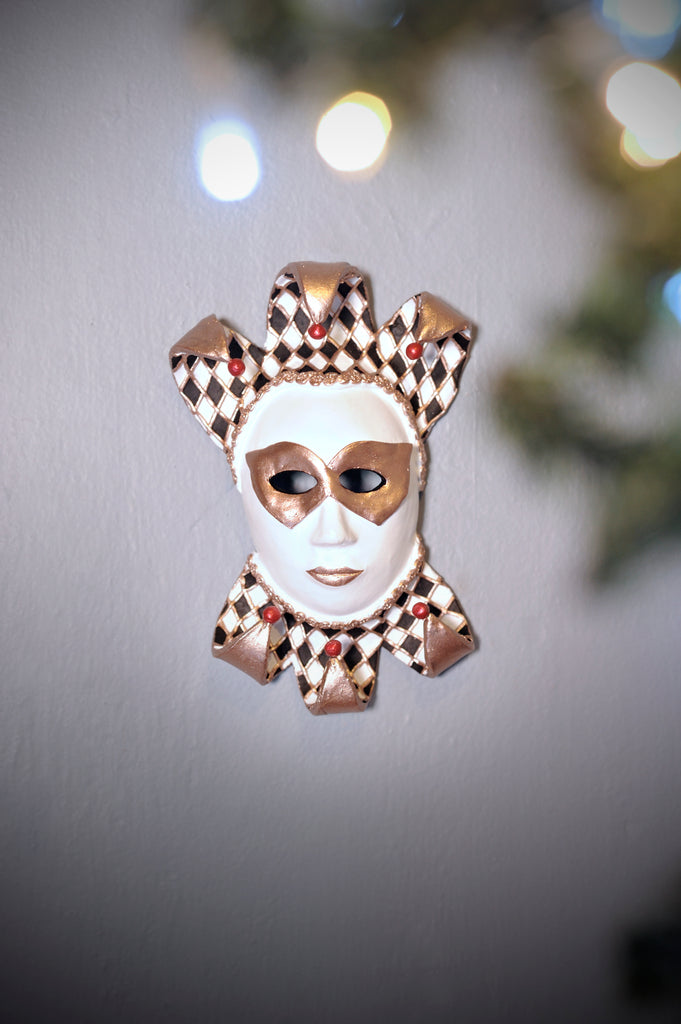 Lorenzo is a stunning Venetian harlequin. Painted with a black and white diamond pattern with gold outlines that match his gold mask and lips.   This mask goes well with all the Catrinas from our new Christmas 2021 Collection.   Lorenzo can be hung anywhere and will surely give your home a special touch this Christmas!