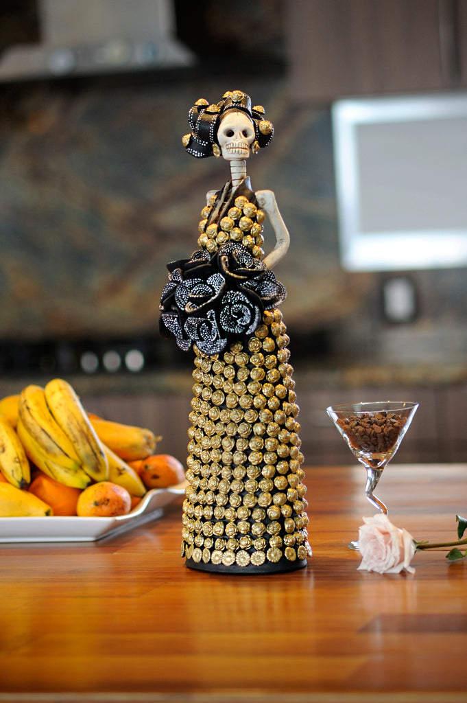 Hand-made clay figurine, Francis is wearing a dress covered in gold rosebuds and a bouquet of dotted black roses. Francis is the perfect Mother's Day gift. Add a classy touch of Mexican art to your home or office. All our Catrinas are made in Mexico and we ship worldwide. 