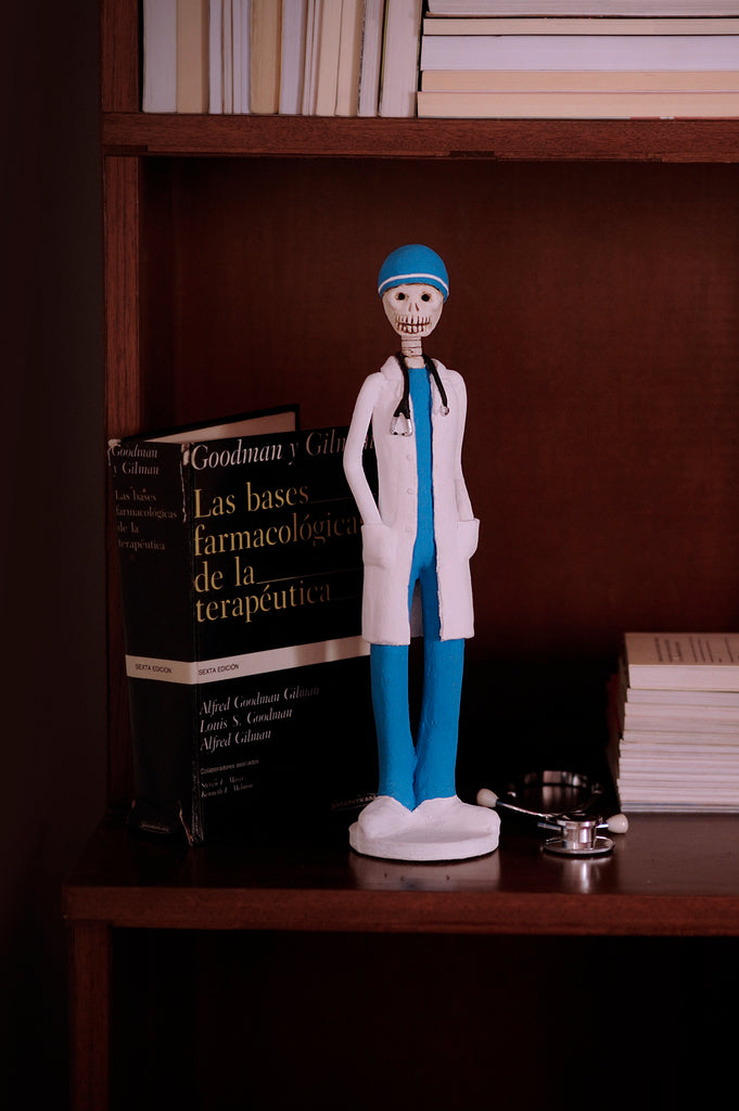 Hand-made clay figurine, Dr.Angel is wearing traditional blue scrubs and a white coat, all our Catrines and Catrinas are made in Mexico, we ship worldwide. Add a classy touch of Mexican art to your home or office. The Earth's Angels collection was created to honor all front-line workers during the covid-19 pandemic. 