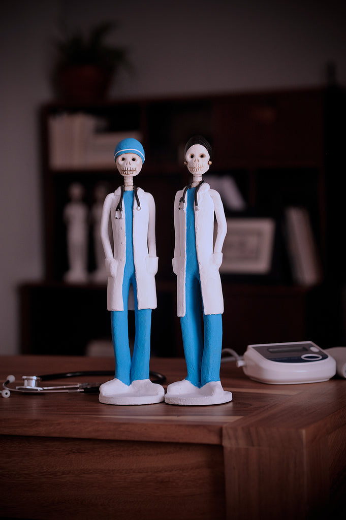 Hand-made clay figurines, Dr.Hope and Dr.Angel are both wearing blue scrubs and white coats, the Earth's Angels collection was made to honor front-line workers during the covid-19 pandemic. All our Catrines and Catrinas are made in Mexico, we ship worldwide. Add a classy touch of Mexican art to your home or office.