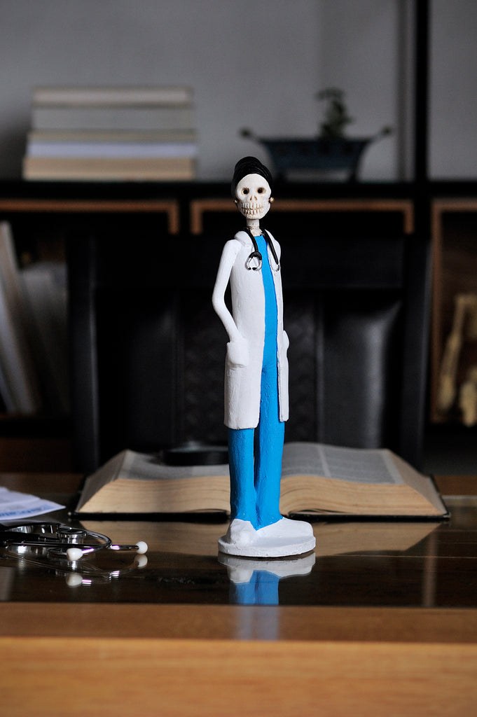 Hand-made clay figurine, Dr.Hope is wearing traditional blue scrubs and a white coat, all our Catrines and Catrinas are made in Mexico, we ship worldwide. Add a classy touch of Mexican art to your home or office. The Earth's Angels collection was created to honor all front-line workers during the covid-19 pandemic. 