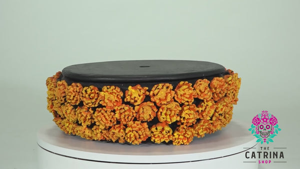 This beautiful centerpiece is the perfect addition to your Day of the Dead altar or as a centerpiece in your home. The Black Cempazuchil centerpiece is decorated with cempazuchil (Marigold) flowers. All of the flowers are individually hand-made and painted by hand.   Each centerpiece comes with a lid that allows you to place decorations on top or inside the centerpiece; if you need some inspiration, check out our pictures.