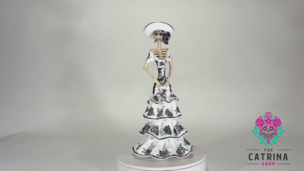 Introducing Catrina Norma from our Grand Collection.  Norma is a stunning Catrina with incredible details on her face and gown. Her gorgeous white dress has black roses that match her headpiece.   Add a classy touch of Mexican art to your home. 