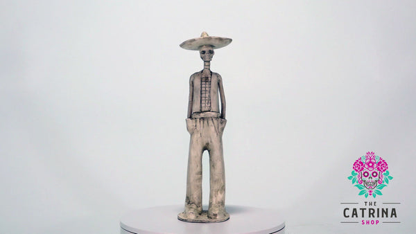 Hand-made clay figurine, Catrin Jaime is part of our Catrin collection. He is painted in Ivory and is a great companion for any of our Catrinas painted in ivory. All our Catrines and Catrinas are made in Mexico and we ship worldwide. Add a classy touch of Mexican art to your home.